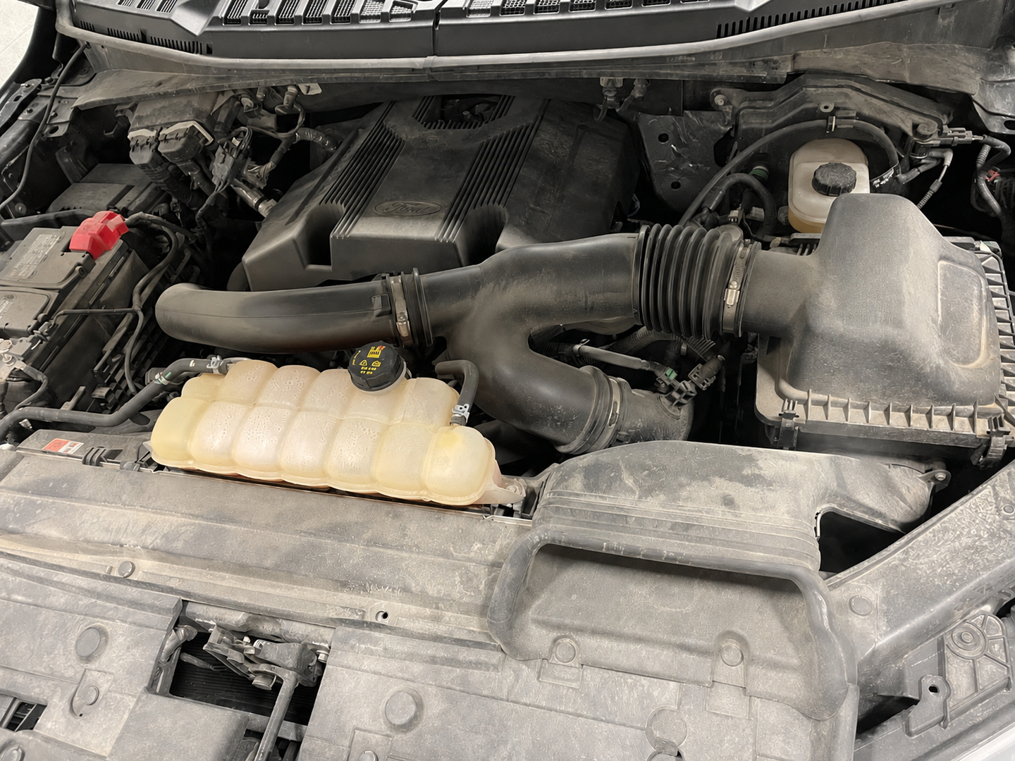 Ford engine bay before detailing